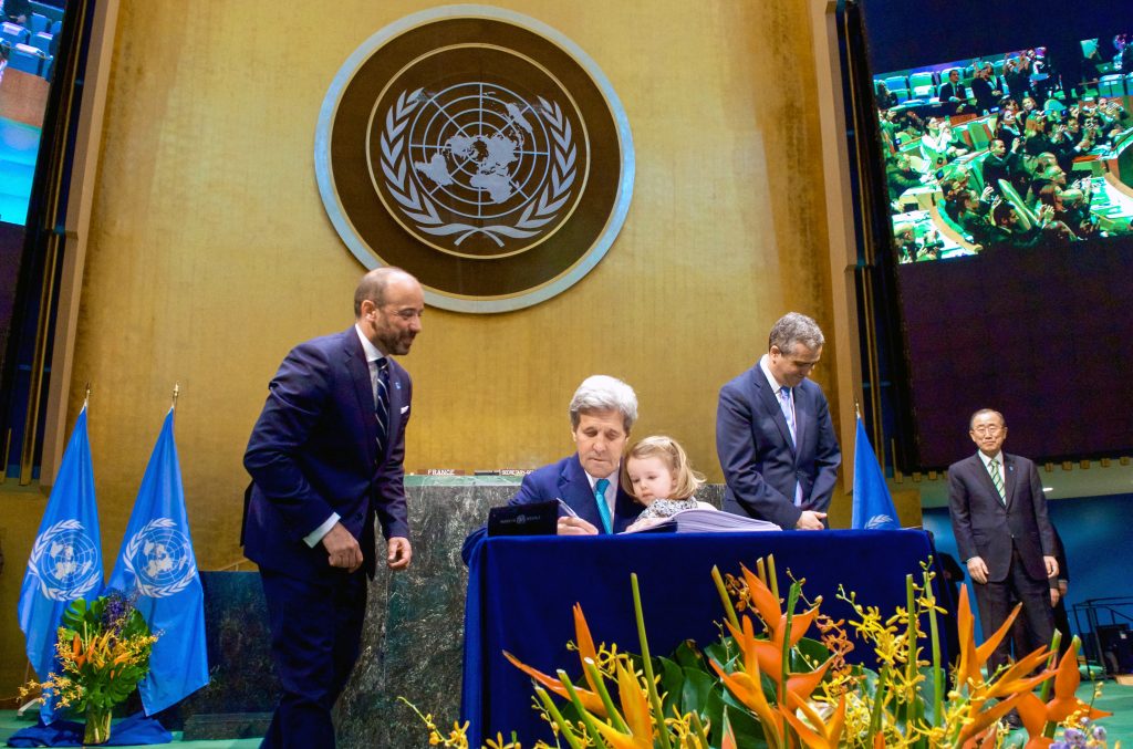 Secretary Kerry signing COP21 document