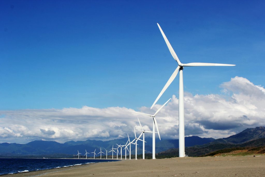 Windmills against a blue sky with white clouds