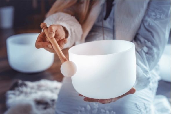 person playing crystal singing bowl