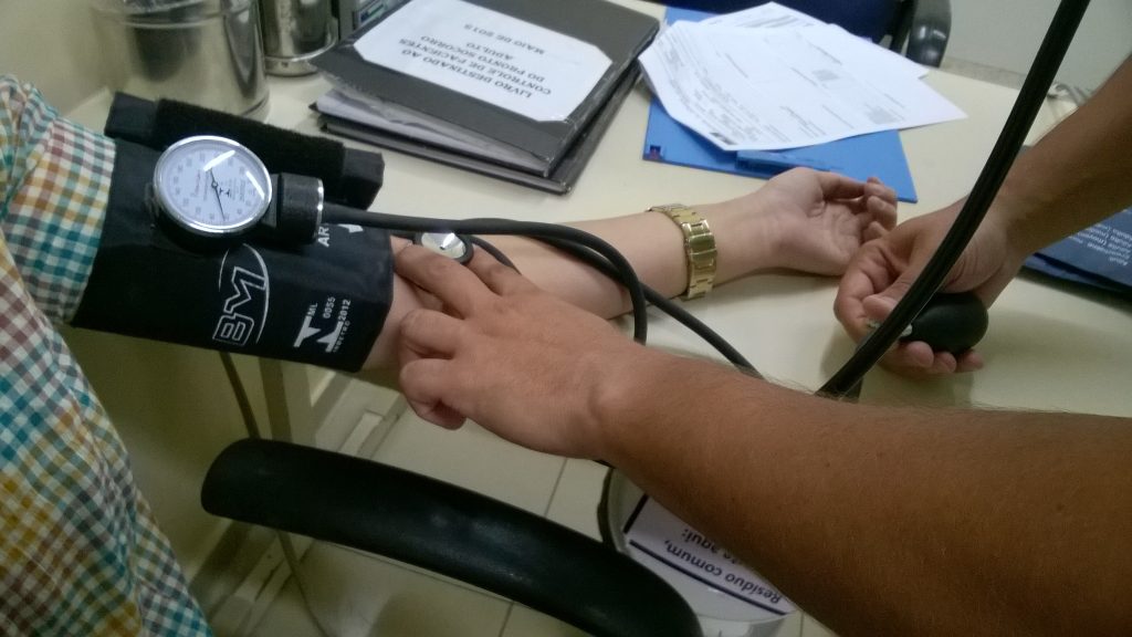 Nurse taking blood pressure of patient